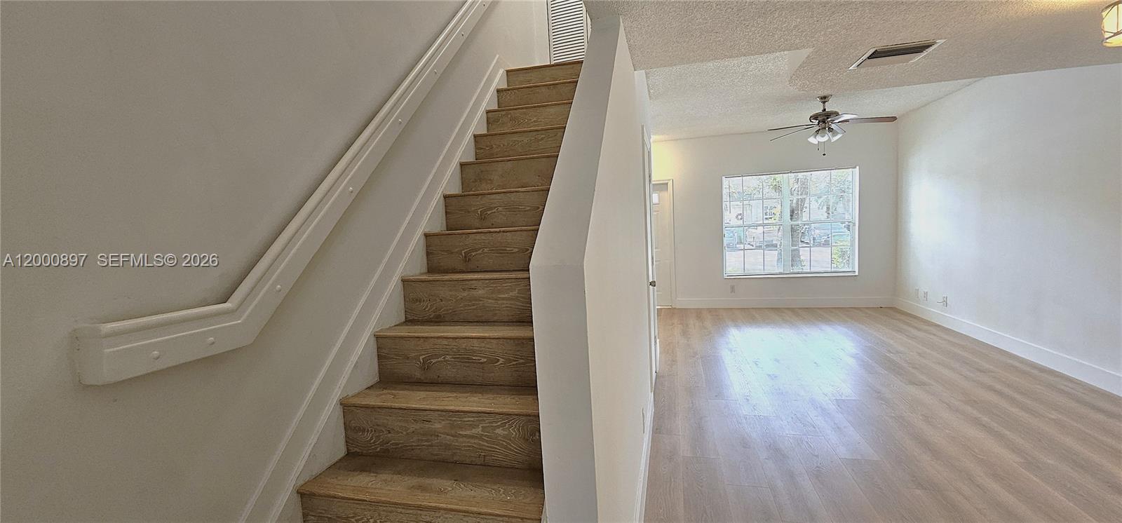 46 Simonton Circle Weston, FL 33326 - Photo 7 of 14 a view of an entryway with wooden floor and staircase