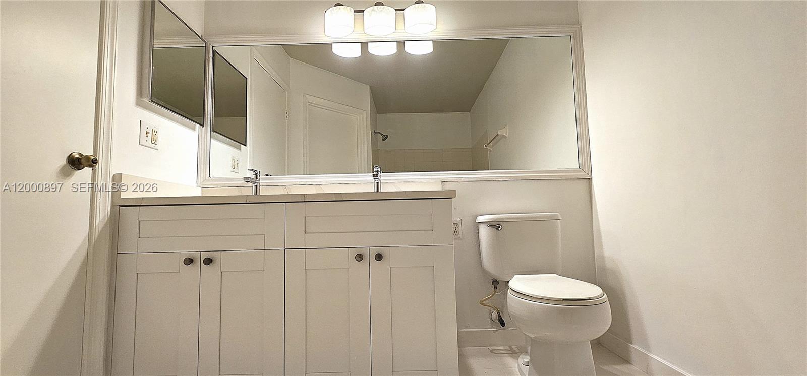 46 Simonton Circle Weston, FL 33326 - Photo 9 of 14 a bathroom with a toilet sink and mirror