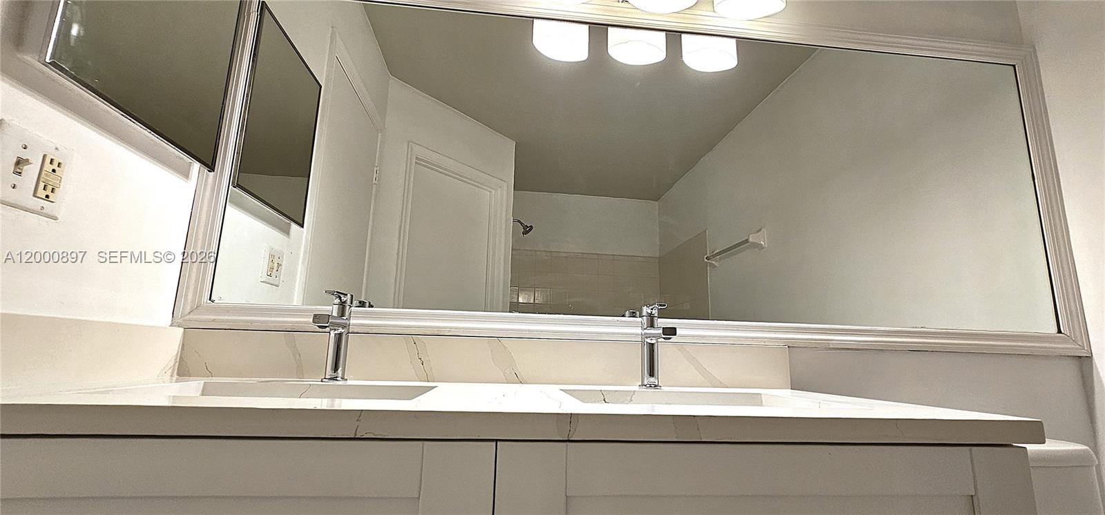 46 Simonton Circle Weston, FL 33326 - Photo 10 of 14 a bathroom with a sink and a mirror
