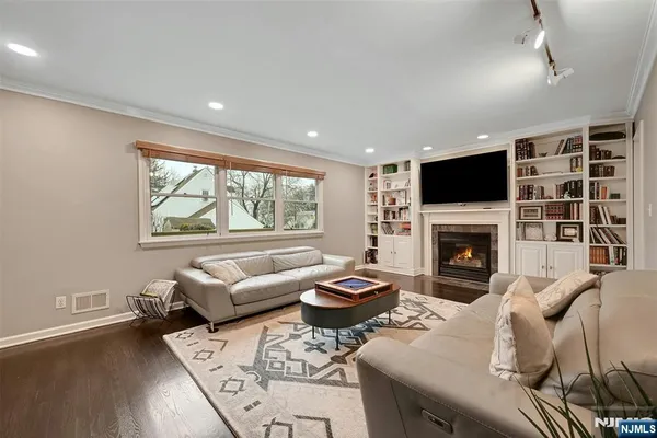 a living room with furniture a fireplace and a flat screen tv