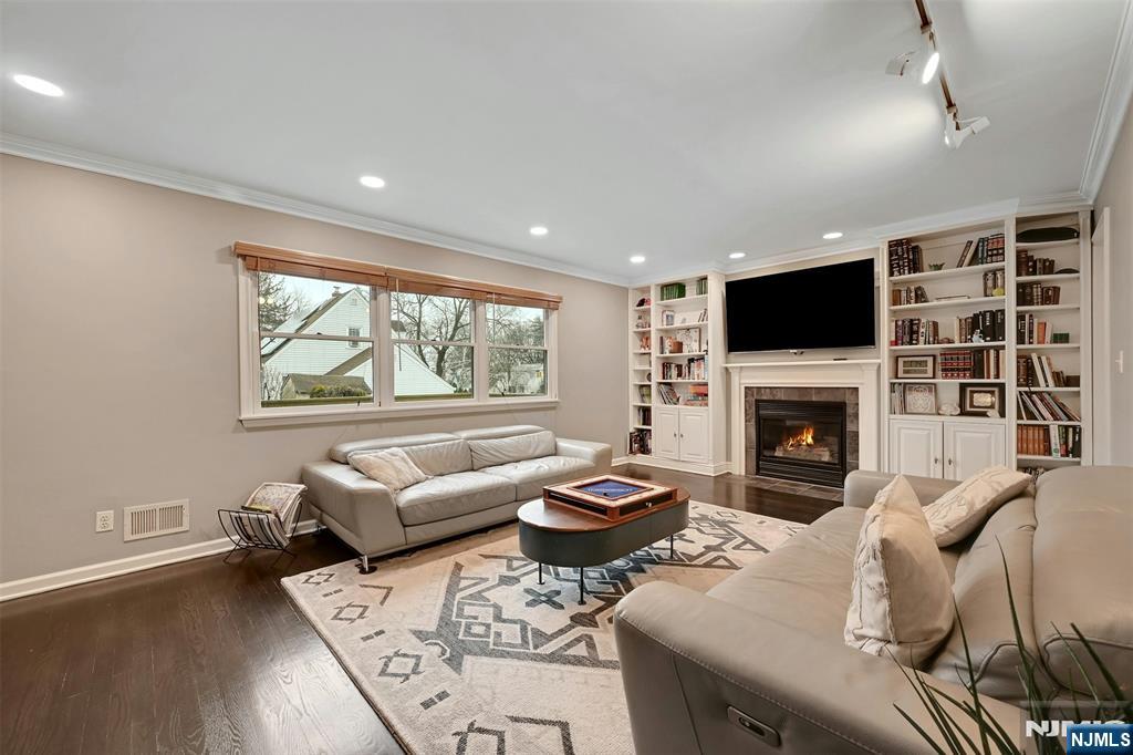 a living room with furniture a fireplace and a flat screen tv