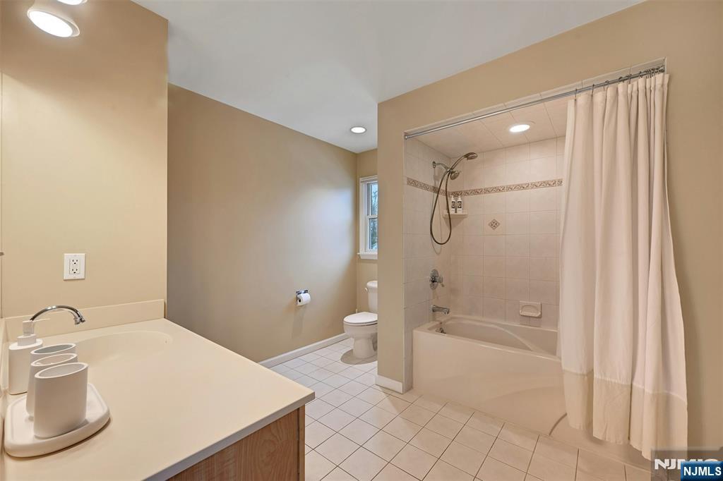 288 Schley Place Teaneck, NJ 07666 - Photo 11 of 29 a bathroom with a sink a toilet and shower