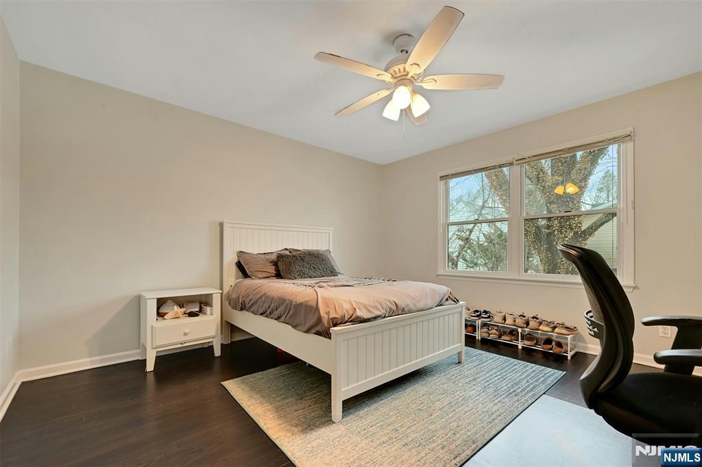 288 Schley Place Teaneck, NJ 07666 - Photo 13 of 29 a bedroom with a bed a window and a chandelier
