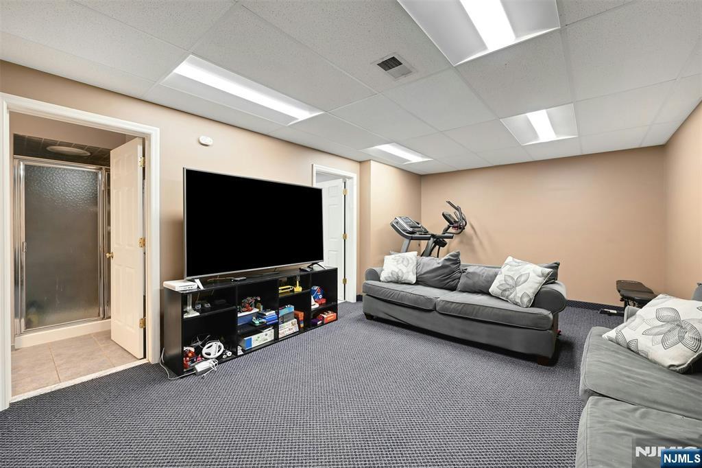 288 Schley Place Teaneck, NJ 07666 - Photo 18 of 29 a living room with furniture and a flat screen tv