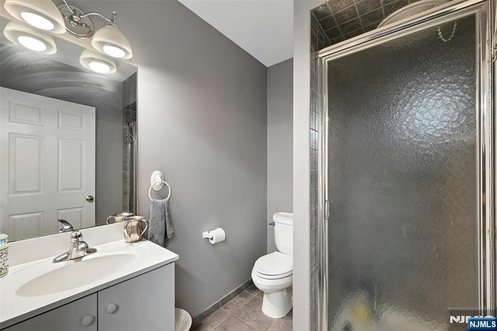 288 Schley Place Teaneck, NJ 07666 - Photo 19 of 29 a bathroom with a toilet a sink and a mirror