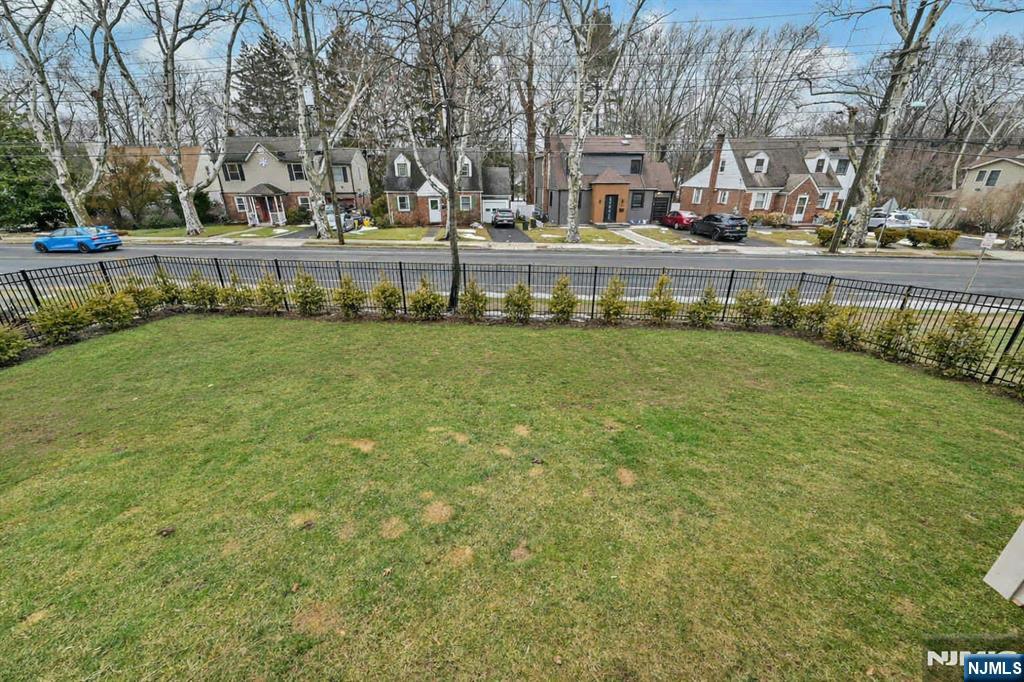 288 Schley Place Teaneck, NJ 07666 - Photo 25 of 29 a front view of a house with a yard