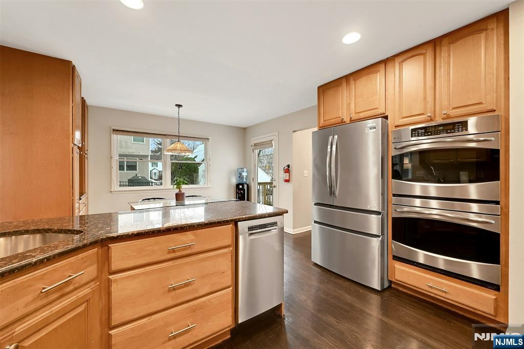 288 Schley Place Teaneck, NJ 07666 - Photo 5 of 29 a kitchen with granite countertop white cabinets and stainless steel appliances