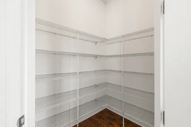 a view of walk in closet with empty racks