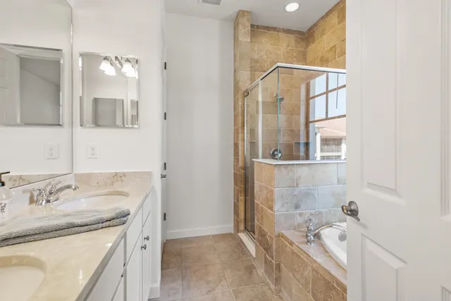 a bathroom with a bathtub and shower