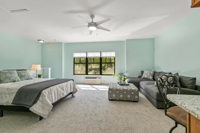 a bedroom with a bed and a window