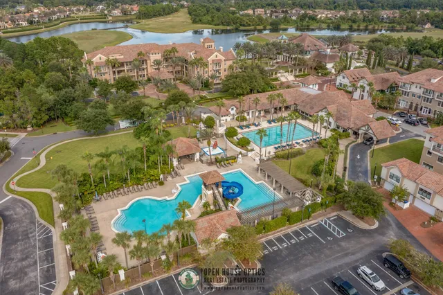 an aerial view of residential houses with outdoor space and swimming pool