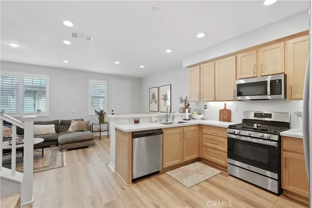 a large kitchen with stainless steel appliances lots of counter top space