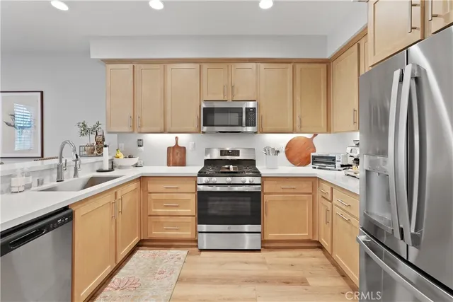 a kitchen with a stove sink and refrigerator