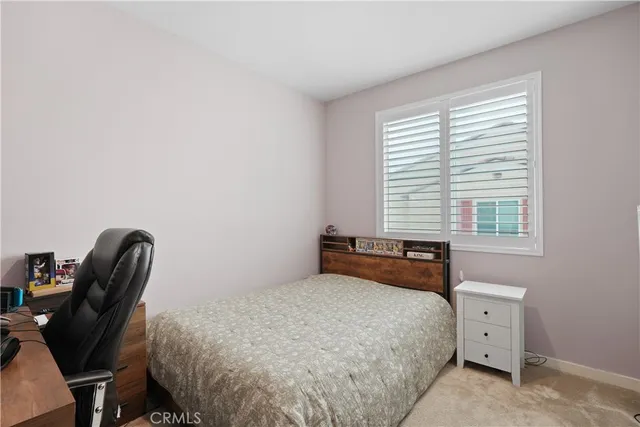 a bedroom with a bed and a desk