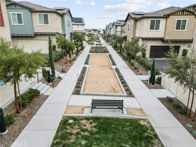 an aerial view of a house with garden space and street view