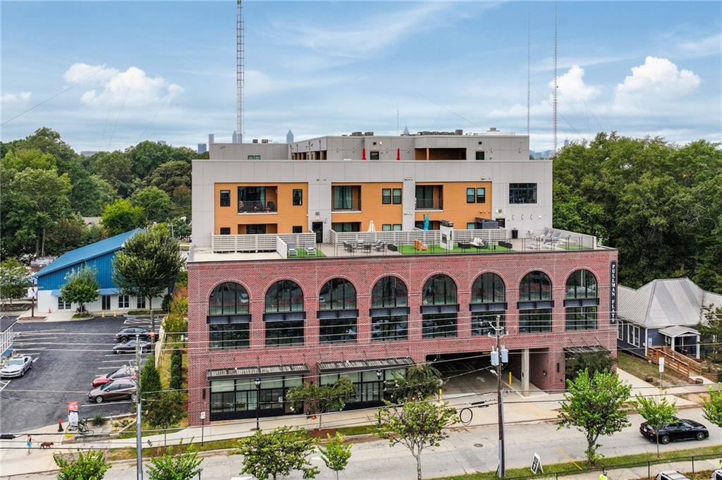 112 Rogers Street Northeast, Unit 202 Atlanta, GA 30317 - Photo 1 of 36 a aerial view of a brick building next to a yard