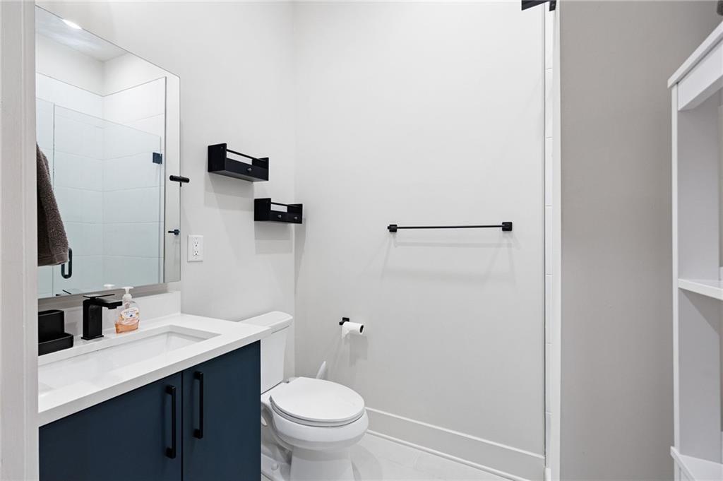 112 Rogers Street Northeast, Unit 202 Atlanta, GA 30317 - Photo 12 of 36 a bathroom with a sink a toilet and shower