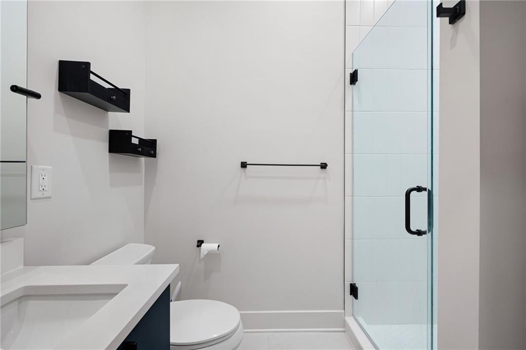 112 Rogers Street Northeast, Unit 202 Atlanta, GA 30317 - Photo 13 of 36 a bathroom with a sink a toilet and shower