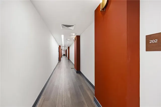 a view of a hallway with wooden floor