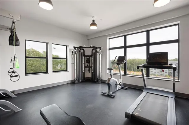 a view of a livingroom with lounge chair and a large window