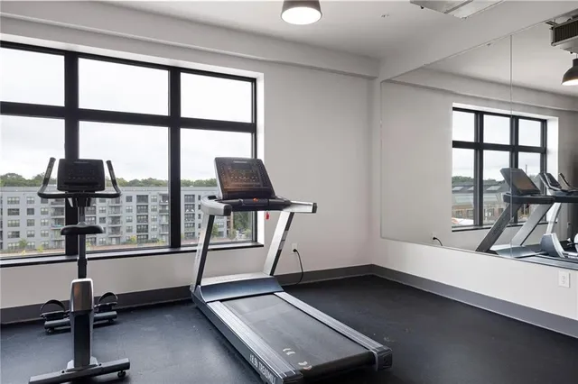 a room with gym equipment and a large window
