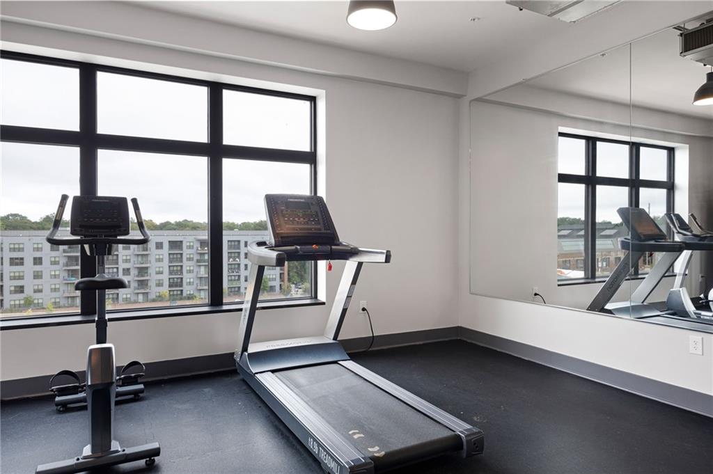 112 Rogers Street Northeast, Unit 202 Atlanta, GA 30317 - Photo 18 of 36 a room with gym equipment and a large window