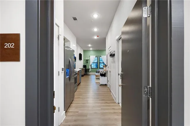 a view of a hallway with wooden floor