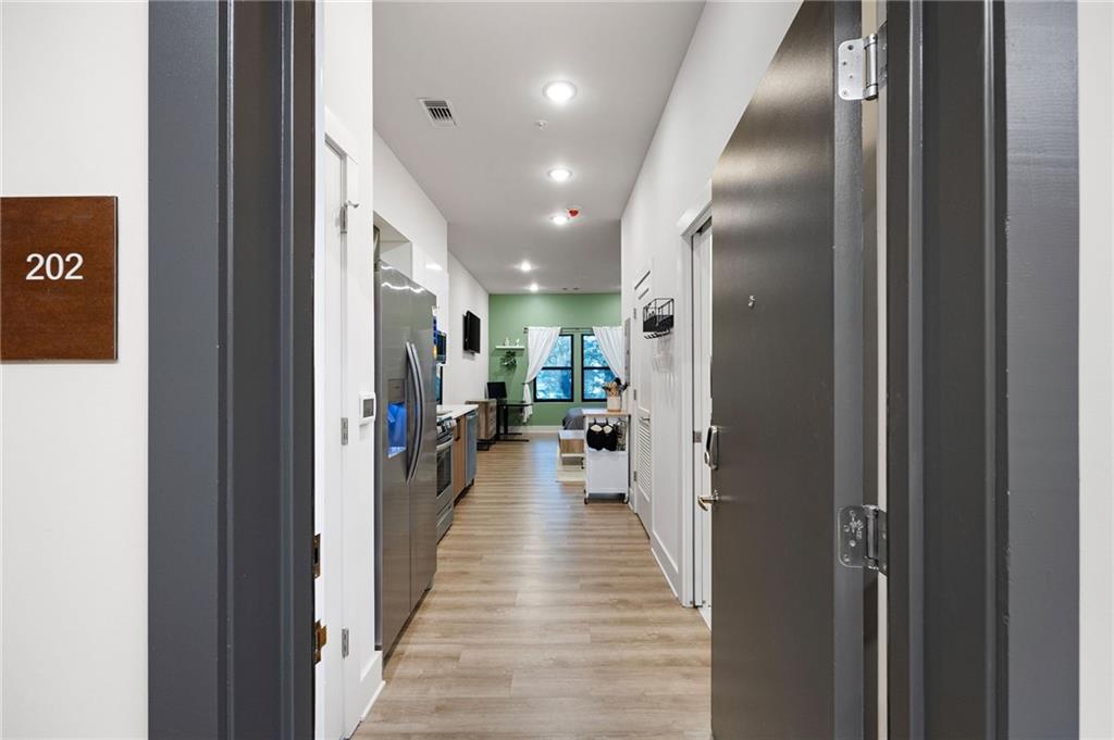 112 Rogers Street Northeast, Unit 202 Atlanta, GA 30317 - Photo 2 of 36 a view of a hallway with wooden floor