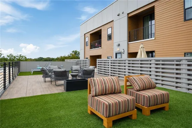 a view of a patio with couches chairs and a yard