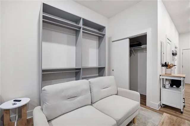 a living room with furniture and a walk in closet