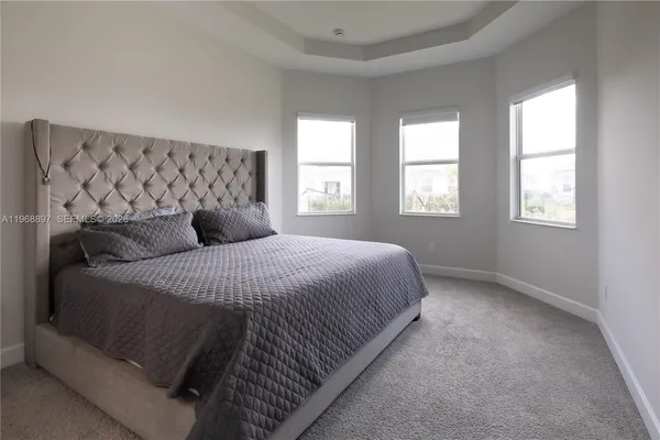 a bedroom with a bed and mirror