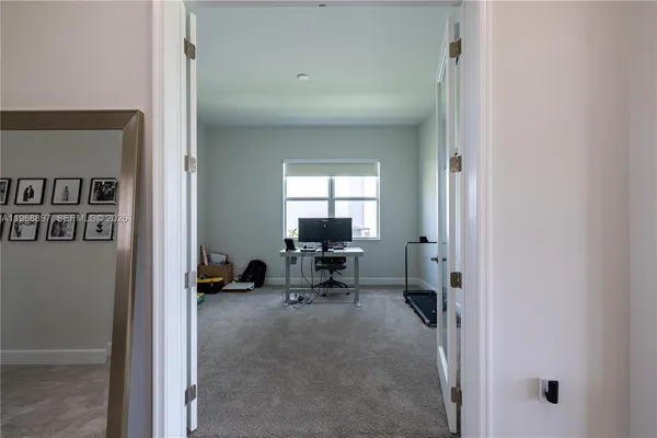 an empty room with closet and mirror