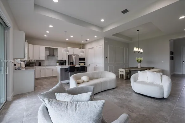 a living room with furniture and kitchen view