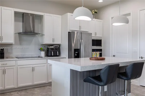 a kitchen with cabinets and stainless steel appliances