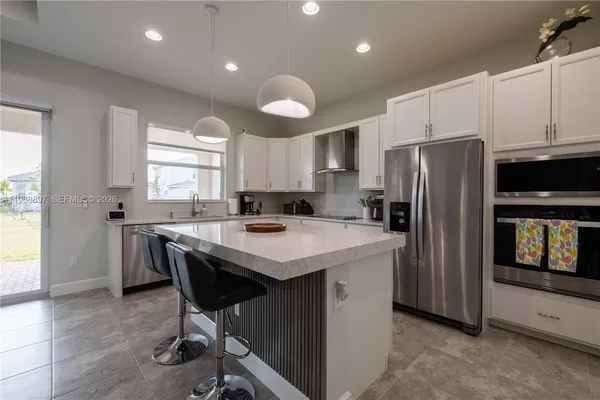 a kitchen with refrigerator a stove a sink and a refrigerator