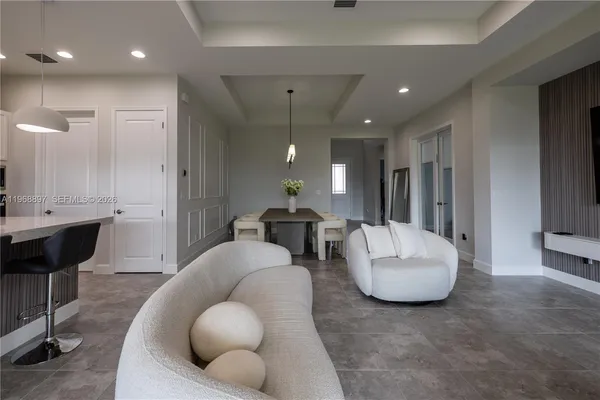 a living room with furniture and a large mirror