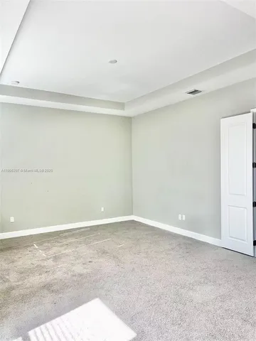 a spacious bathroom with a granite countertop sink and a mirror