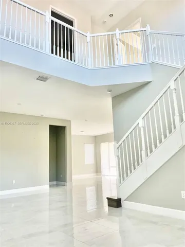 a kitchen that has a lot of white cabinets