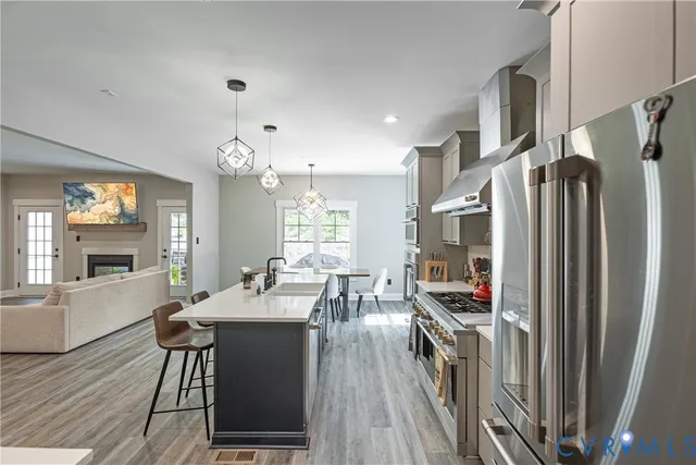 a kitchen with stainless steel appliances a sink stove and cabinets