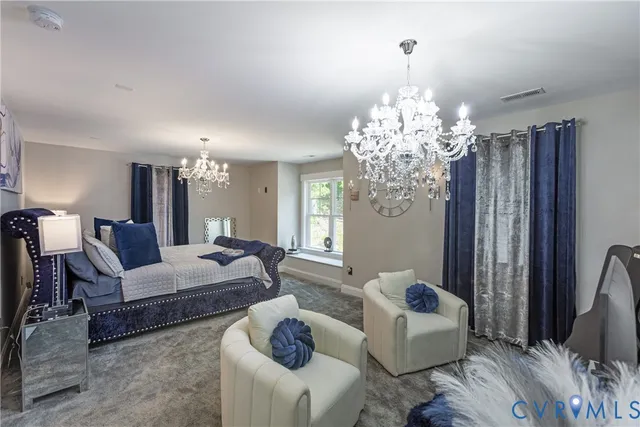 a bedroom with furniture and a large window