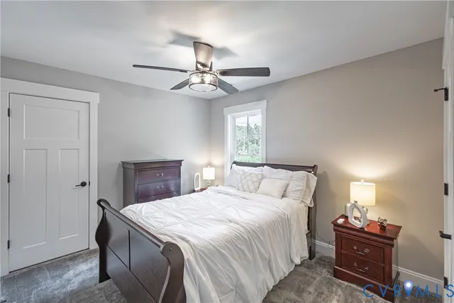 a spacious bedroom with bed and a chandelier