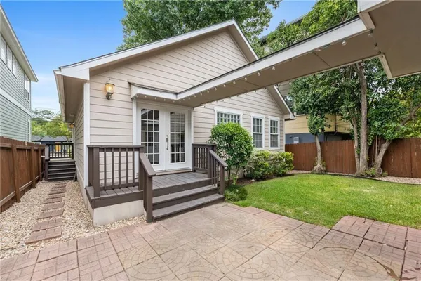 a view of backyard with deck and garden
