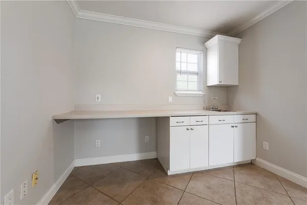 a kitchen with cabinets appliances a sink and a window