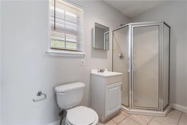a bathroom with a toilet a sink and a window