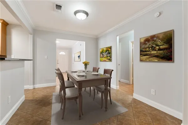 a view of a dining room with a table and chairs