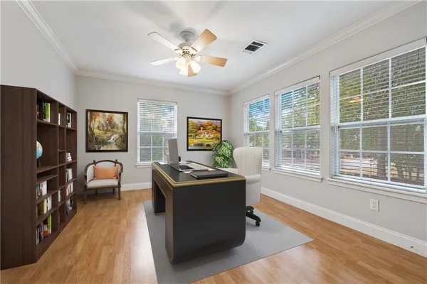 a work room with furniture and a flat screen tv