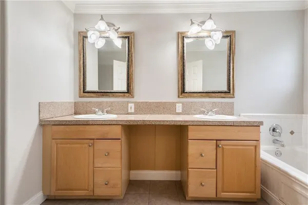 a bathroom with a sink double vanity and a mirror