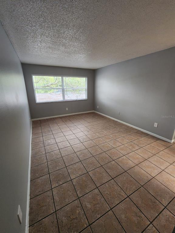 101 North Fernwood Avenue, Unit 6 Clearwater, FL 33765 - Photo 5 of 12 a view of an empty room and windows