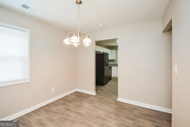 a view of a chandelier in big room and chandelier