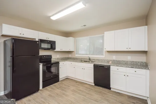 a kitchen with a refrigerator stove and sink